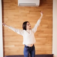 Young attractive woman work at home stretching arms to relax after working day
